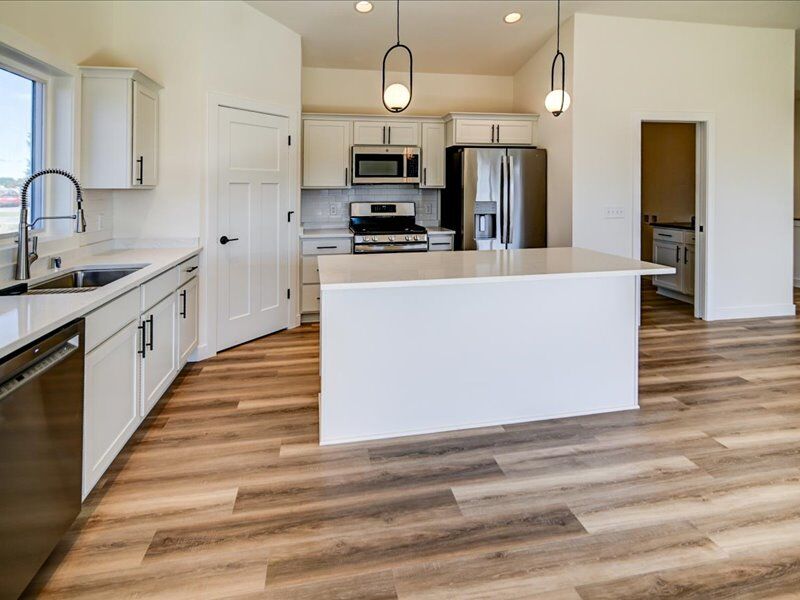 Kitchen with island and pendant lights