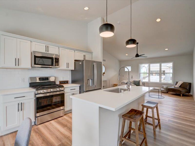 Kitchen with island, pendant lights and stainless appliances