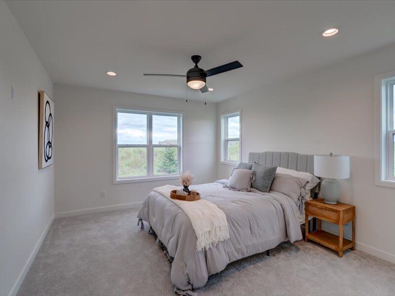 Primary bedroom with ceiling fan
