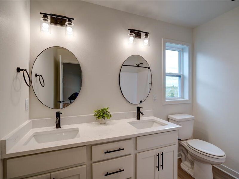 Bathroom with double vanity and round mirrors