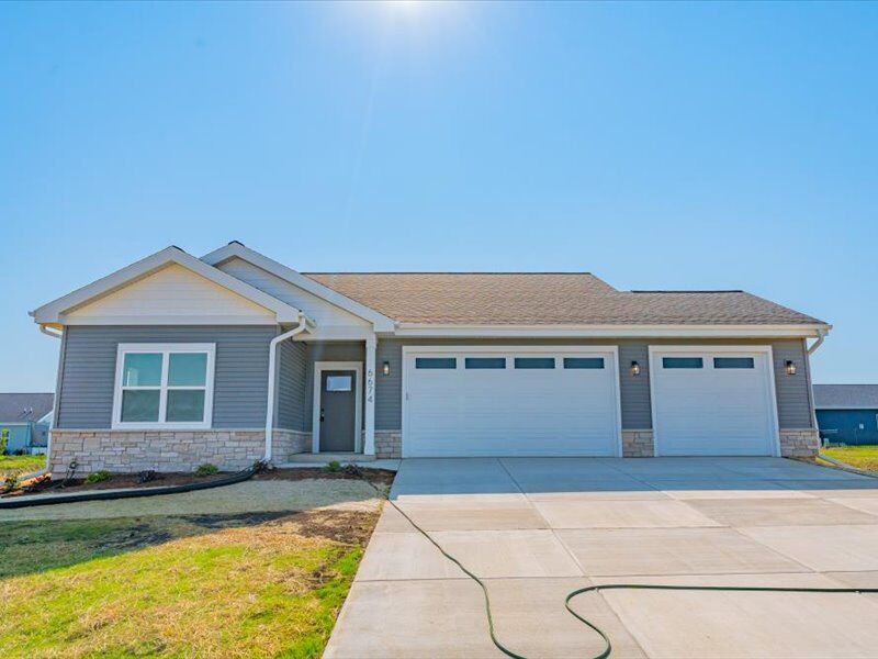 Front of 6674 Warner Farm Drive with a three-car garage