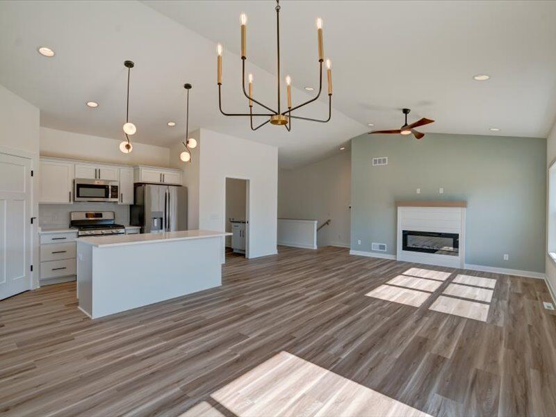 Open great room with fireplace and vaulted ceiling
