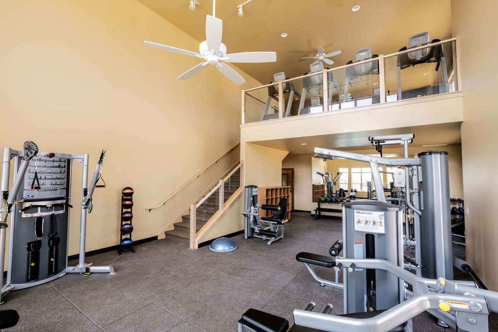 Two-story fitness center with weight machines and a loft